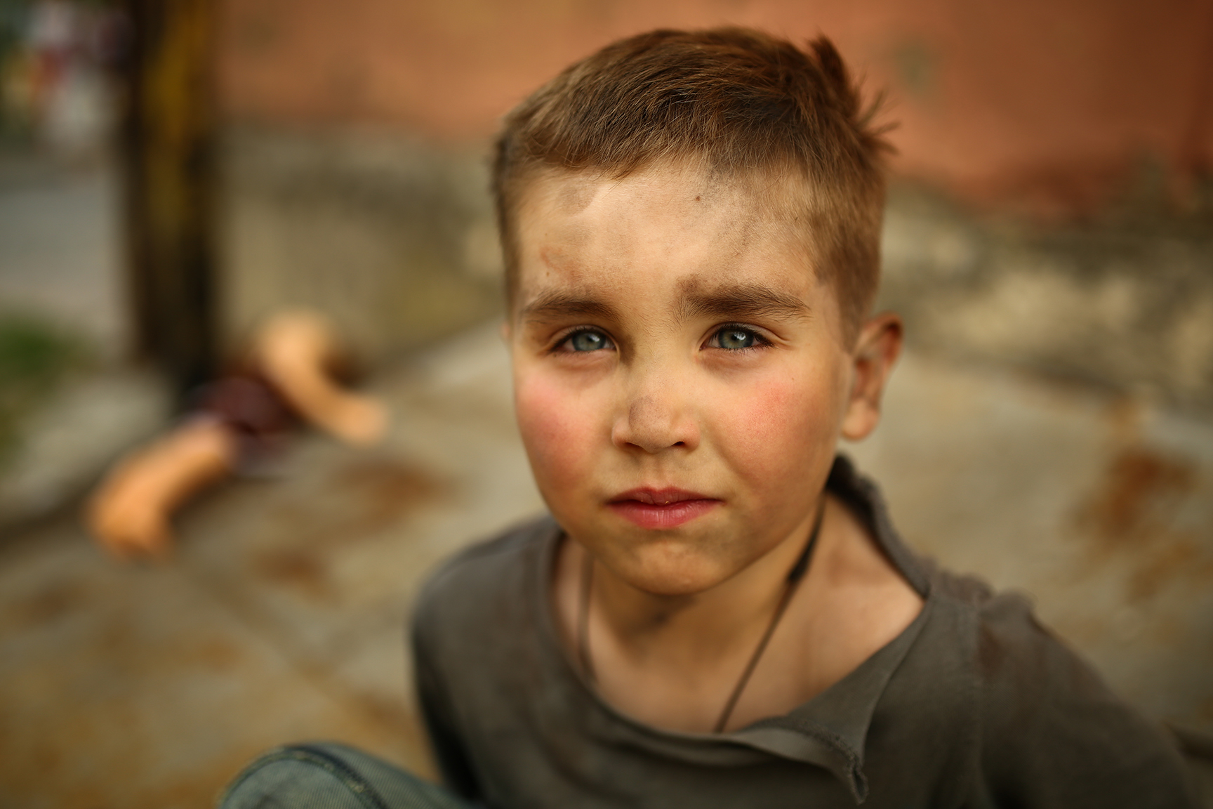alone sad child playing on a street